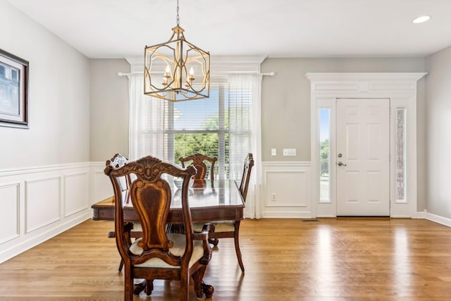 dining room featuring an inviting chandelier, light wood-type flooring, and a healthy amount of sunlight