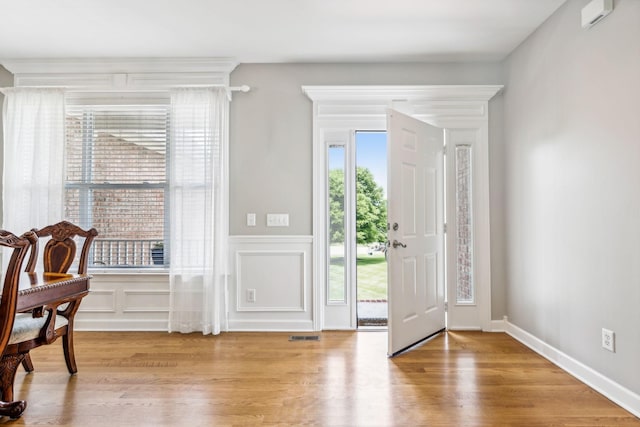 entryway with light hardwood / wood-style flooring and plenty of natural light