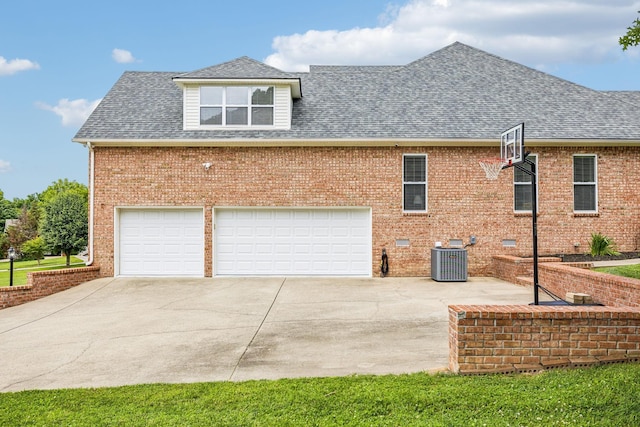 view of property exterior featuring central AC and a garage