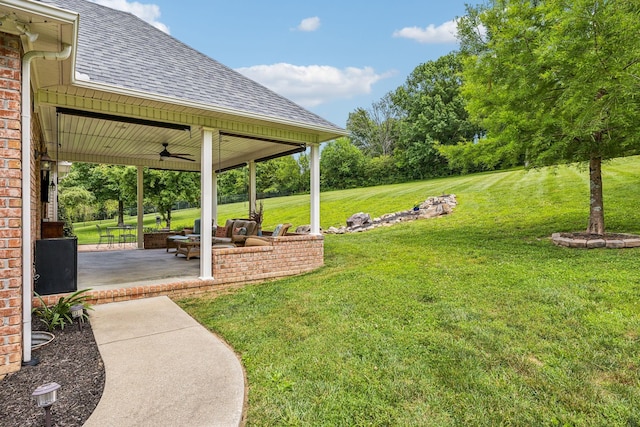 view of yard featuring a patio area and ceiling fan