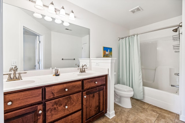 full bathroom with tile patterned flooring, shower / bath combo with shower curtain, vanity, and toilet