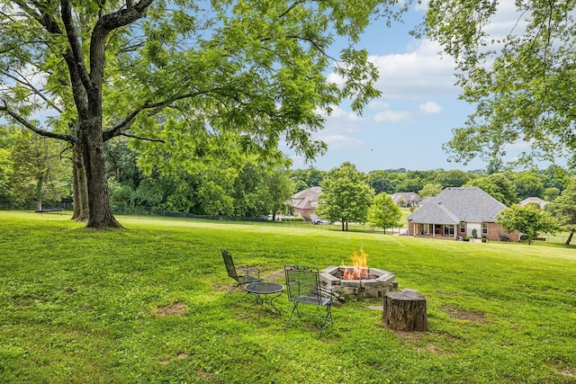 view of yard with a fire pit