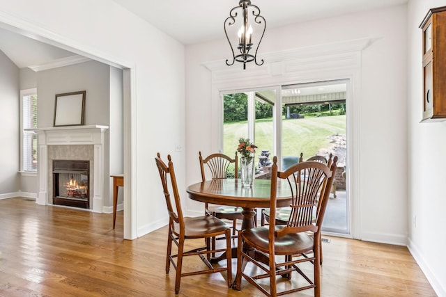 dining room with light wood-type flooring and a chandelier