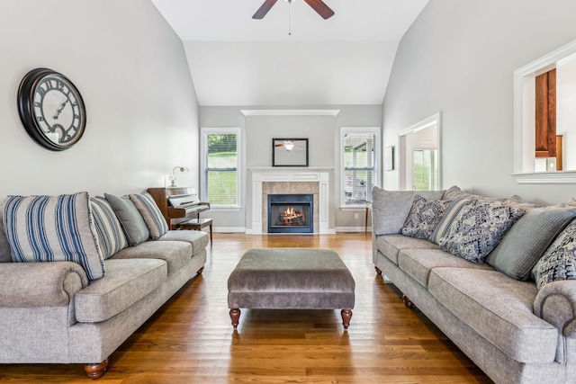 living room featuring lofted ceiling, hardwood / wood-style floors, and ceiling fan