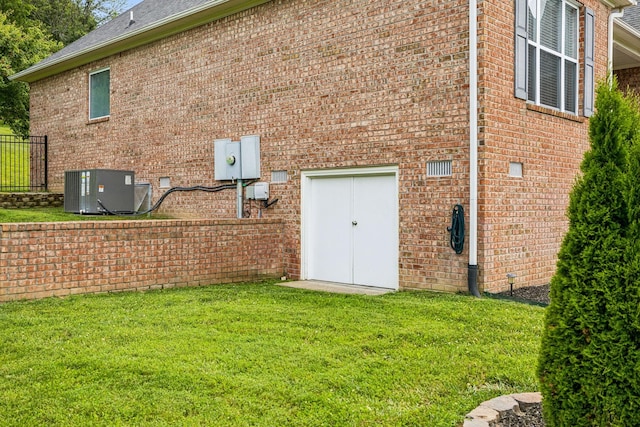 exterior space featuring central AC unit and a yard