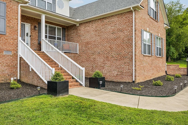 view of home's exterior with a porch and a yard