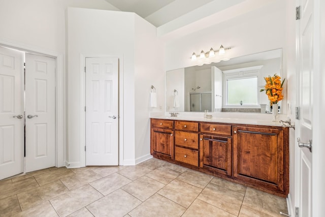 bathroom with walk in shower and tile patterned floors