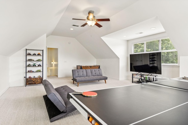 recreation room with ceiling fan, light colored carpet, and lofted ceiling