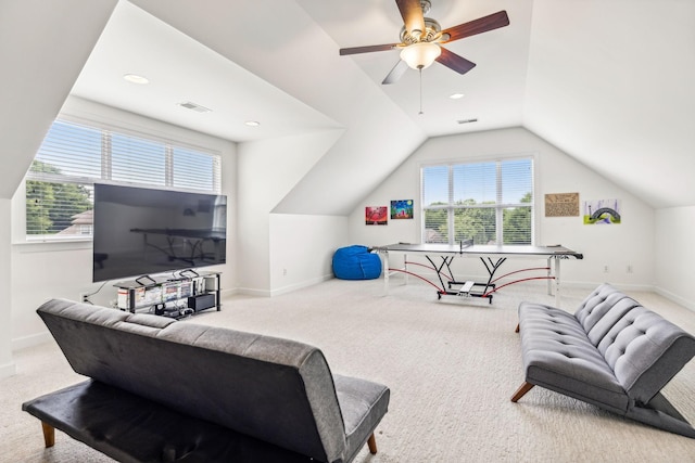 interior space featuring ceiling fan, vaulted ceiling, and carpet floors