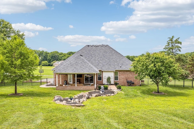 back of house with a lawn and a patio area