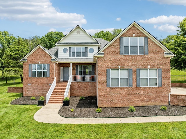 front facade featuring a front yard and covered porch