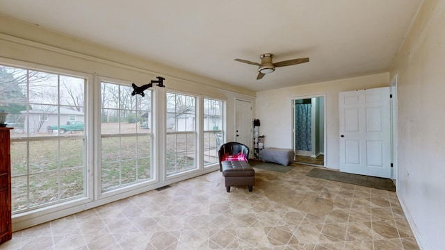 sitting room featuring ceiling fan and a healthy amount of sunlight