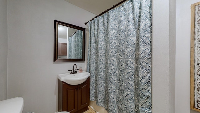 bathroom featuring toilet, a shower with curtain, and vanity