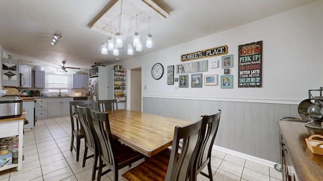 tiled dining room featuring ceiling fan