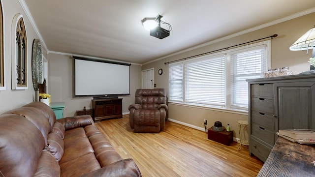 cinema room featuring ornamental molding, a healthy amount of sunlight, and light hardwood / wood-style flooring