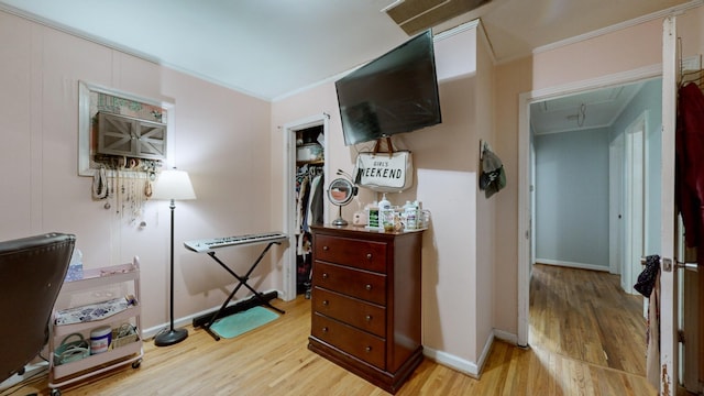 interior space with light hardwood / wood-style floors and ornamental molding