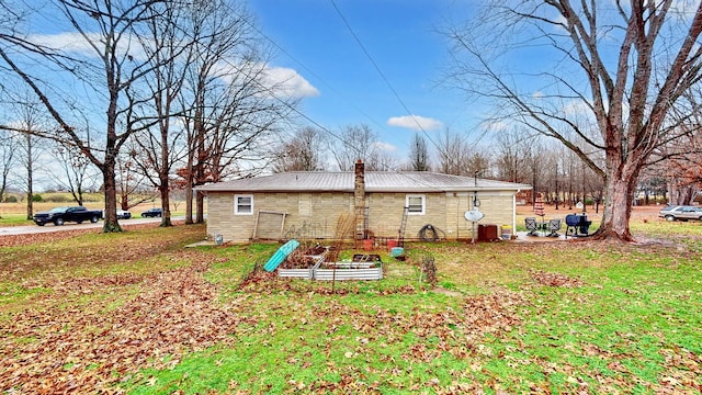 view of side of property with a lawn