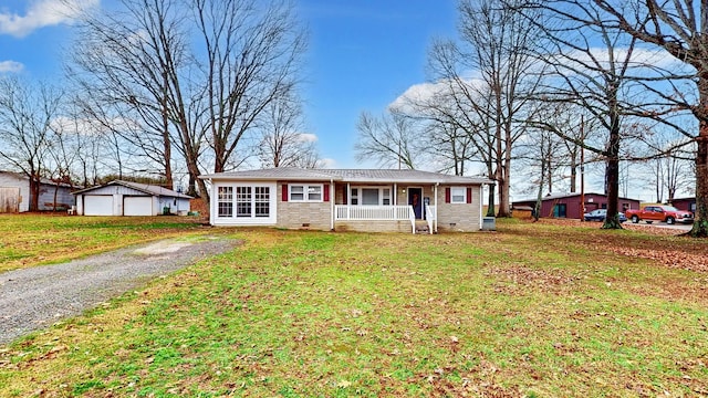 ranch-style house featuring a porch, a front lawn, a garage, and an outdoor structure