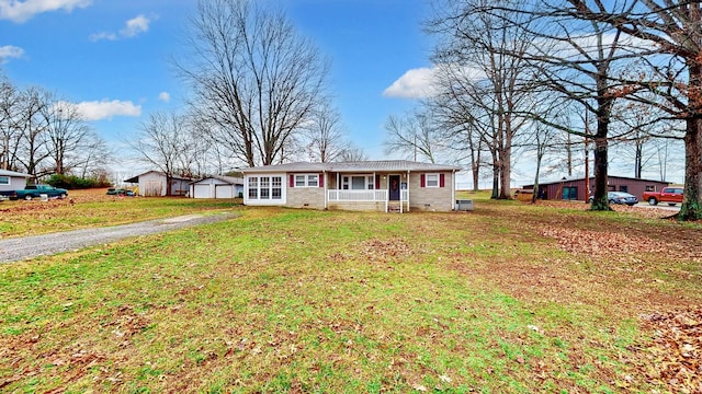 ranch-style house featuring a porch and a front lawn