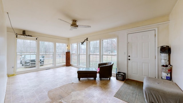 sunroom featuring ceiling fan