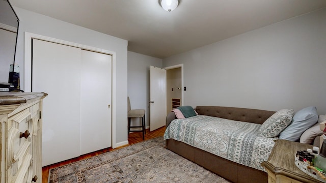 bedroom with a closet and hardwood / wood-style floors