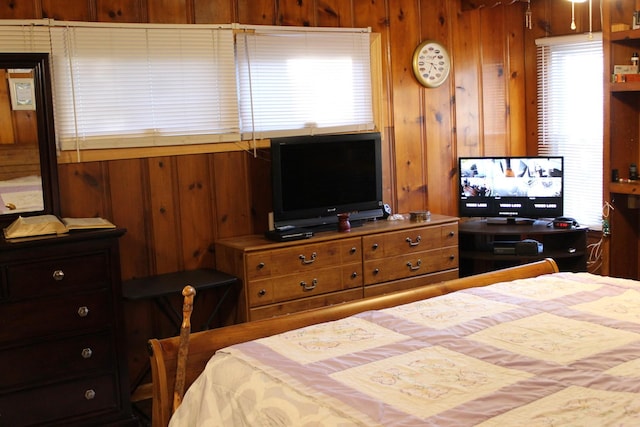 bedroom featuring wood walls