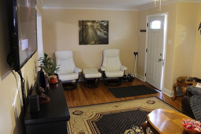 living room with wood-type flooring and ornamental molding