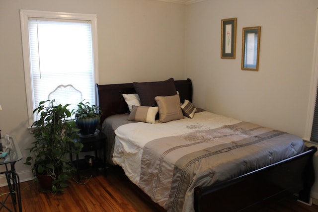 bedroom with dark hardwood / wood-style flooring