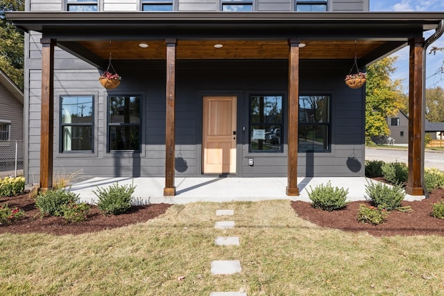 view of exterior entry featuring a yard