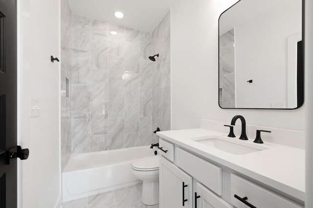 full bathroom with toilet, tiled shower / bath combo, and vanity