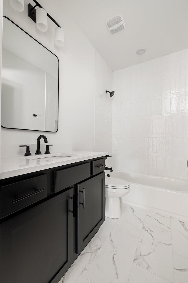 full bathroom featuring toilet, tiled shower / bath, and vanity