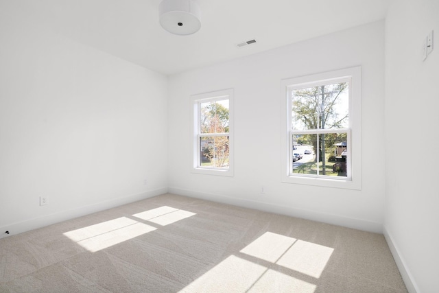 empty room featuring light colored carpet