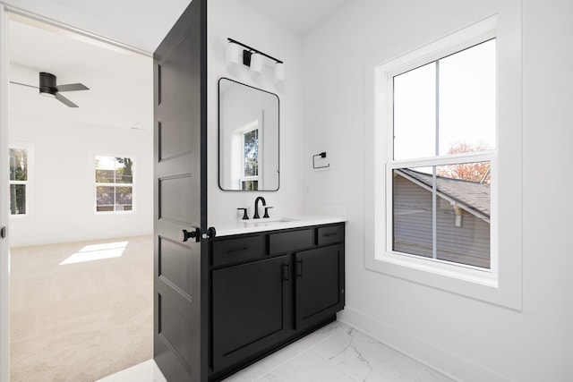 bathroom with ceiling fan, a wealth of natural light, and vanity