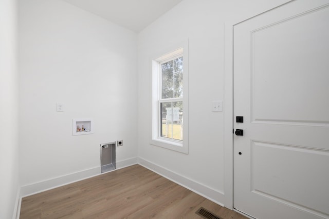 washroom with electric dryer hookup, light wood-type flooring, plenty of natural light, and washer hookup