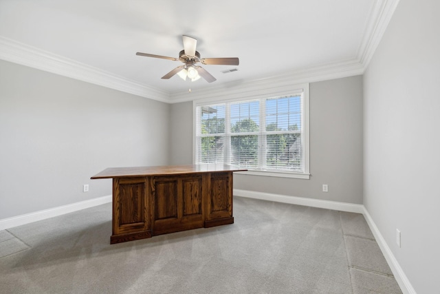 unfurnished office featuring ornamental molding, ceiling fan, and light carpet