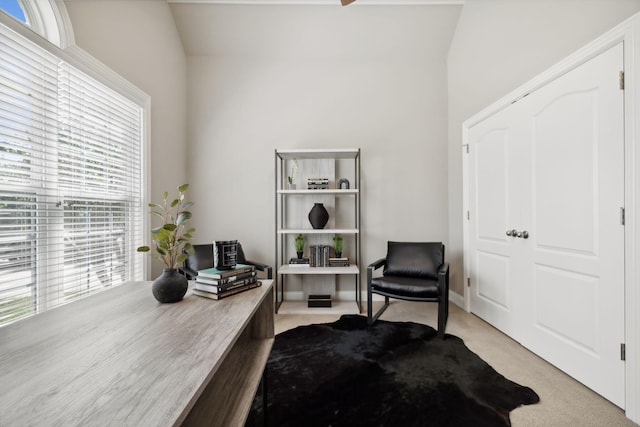 carpeted home office with lofted ceiling