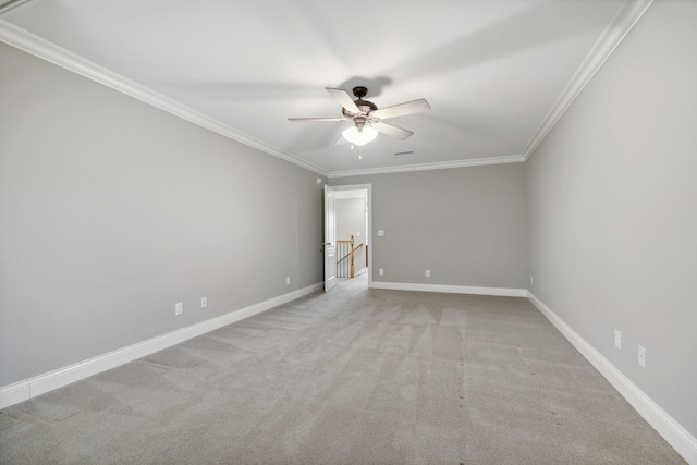 carpeted empty room featuring ceiling fan and crown molding