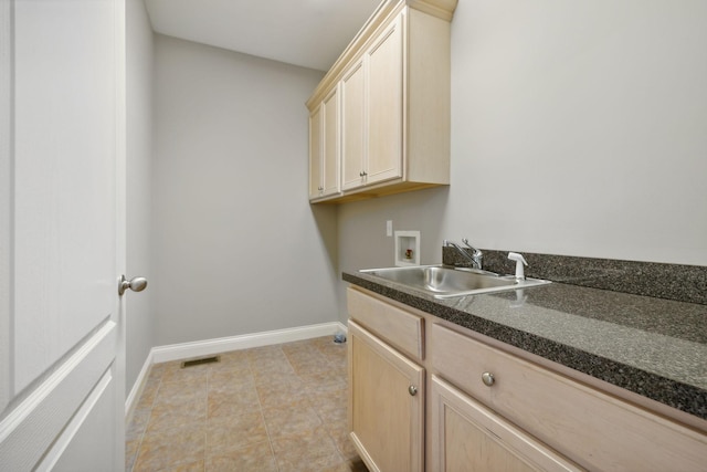 laundry area with sink, washer hookup, and cabinets