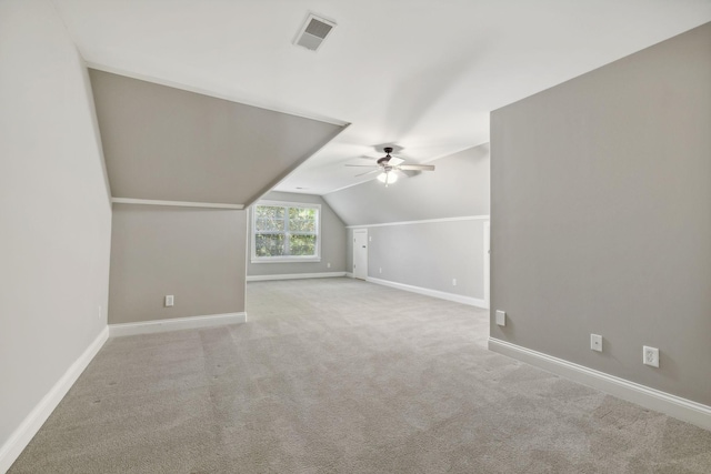 additional living space with lofted ceiling, light colored carpet, and ceiling fan