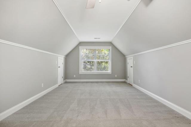 additional living space featuring lofted ceiling, light carpet, and ceiling fan