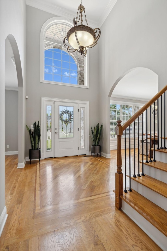 foyer with a high ceiling and ornamental molding