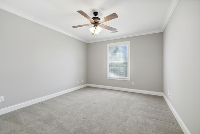 spare room with light carpet, ceiling fan, and crown molding