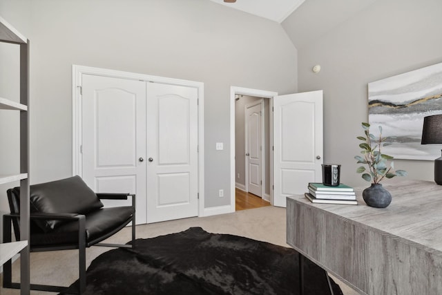 bedroom featuring vaulted ceiling, a closet, and light carpet