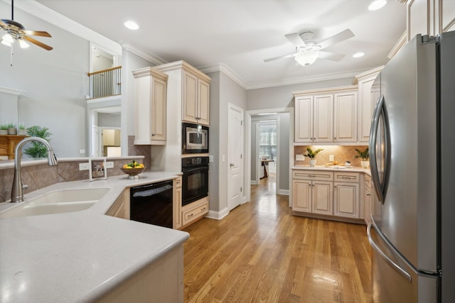 kitchen with black appliances, ornamental molding, sink, light hardwood / wood-style flooring, and backsplash