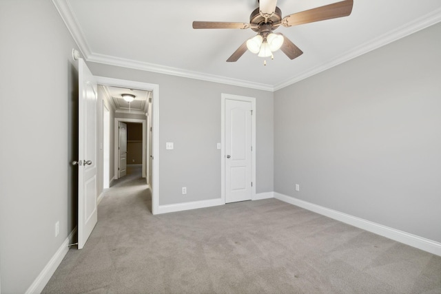 unfurnished bedroom with light colored carpet, ceiling fan, crown molding, and a closet