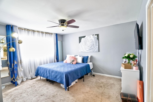 bedroom with ceiling fan and light carpet