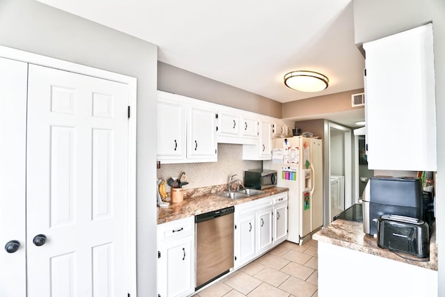 kitchen featuring stainless steel appliances, sink, white cabinetry, independent washer and dryer, and tasteful backsplash