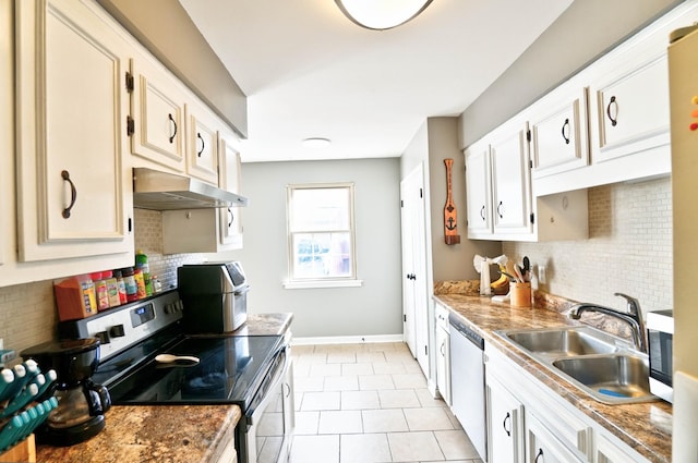 kitchen with appliances with stainless steel finishes, white cabinets, light tile patterned flooring, and sink