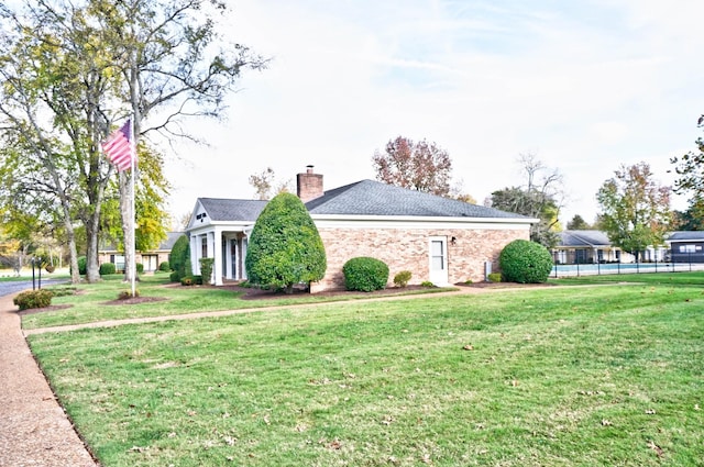 view of side of home featuring a yard