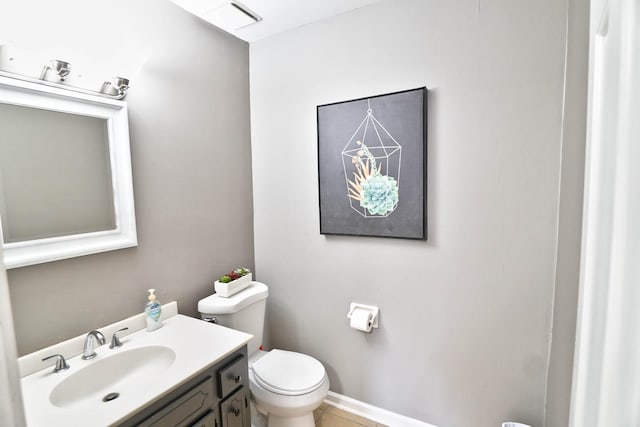 bathroom featuring toilet, vanity, and tile patterned flooring